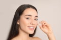 Young woman with ice cube on light background. Royalty Free Stock Photo