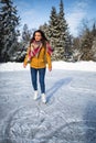 Young woman ice skating outdoors on a pond Royalty Free Stock Photo