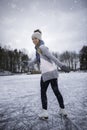 Young woman ice skating outdoors on a pond Royalty Free Stock Photo