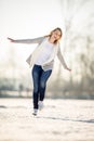 Young woman ice skating outdoors on a pond on a freezing winter Royalty Free Stock Photo