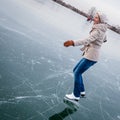 Young woman ice skating outdoors on a pond Royalty Free Stock Photo