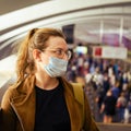 A young woman with an incorrectly put on medical mask in transport