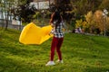 A Young woman Inflates A yellow Lamzac With Air. A woman Inflates An Air Sofa in park.