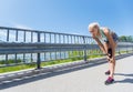 Young woman with injured knee or leg outdoors Royalty Free Stock Photo