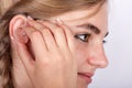 Young woman inserting a hearing aid in her ear Royalty Free Stock Photo