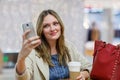 Young woman at international airport, making selfie with mobile Royalty Free Stock Photo