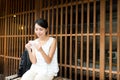 Young Woman in japanese store and eating snack Royalty Free Stock Photo