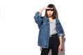 Young woman in jeans jacket looking away into the future monitoring isolated on grey wall background. Human face expressions, Royalty Free Stock Photo