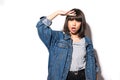 Young woman in jeans jacket looking away into the future monitoring isolated on grey wall background. Human face expressions, Royalty Free Stock Photo