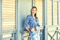 Young woman in jeans and plaid shirt Royalty Free Stock Photo