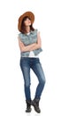 Young Woman In Jeans Vest, Black Boots And Brown Hat Is Looking Up Royalty Free Stock Photo