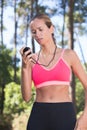 Young woman jogger checking performance on stopwatch