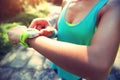 Young woman jogger ready to run set and looking at sports smart watch Royalty Free Stock Photo