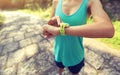 Young woman jogger ready to run set and looking at sports smart watch Royalty Free Stock Photo