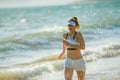 Young woman jogger on seacoast in evening running Royalty Free Stock Photo