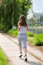 Young woman jogging alongside a river Royalty Free Stock Photo