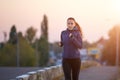 Young woman jogging on bridge in early morning Royalty Free Stock Photo