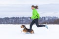 Young woman jogging with a dog Royalty Free Stock Photo