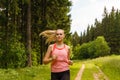 Young woman jogging in the forest Royalty Free Stock Photo