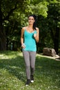 Young woman jogging in nature smiling Royalty Free Stock Photo