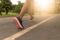 young woman Jogging in the park in the morning under warm sunlight