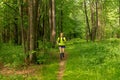 young woman jogging on a path in a natural forest park Royalty Free Stock Photo