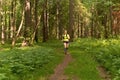 young woman jogging on a path in a natural forest park Royalty Free Stock Photo