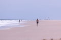 Young woman jogging on a Rehoboth beach on a sunny day