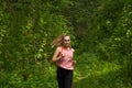 Young woman jogging in sunny forest Royalty Free Stock Photo