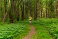 young woman jogging on a trail in a natural forest park Royalty Free Stock Photo