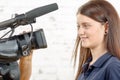 A young woman journalist looks at the camera Royalty Free Stock Photo