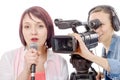 Young woman journalist with a microphone and camerawoman Royalty Free Stock Photo