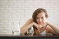 Young woman in joyful postures with jug and glass of drinking water