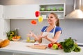 Young woman juggle with vegetables