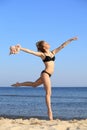 Young woman jumping on beach fit sporty girl Royalty Free Stock Photo