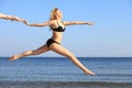 Young woman jumping on beach fit sporty girl Royalty Free Stock Photo
