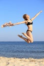 Young woman jumping on beach fit sporty girl Royalty Free Stock Photo