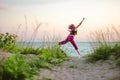 Young woman jumping on the beach towards the sea Royalty Free Stock Photo