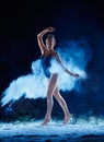 Young woman jumping in blue powder cloud Royalty Free Stock Photo