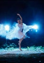 Young woman jumping in blue powder cloud Royalty Free Stock Photo