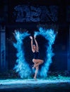 Young woman jumping in blue powder cloud Royalty Free Stock Photo