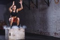 Woman jumping box. Fitness woman doing box jump workout at cross fit gym. Royalty Free Stock Photo