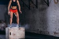 Woman jumping box. Fitness woman doing box jump workout at cross fit gym. Royalty Free Stock Photo