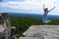 Young woman jumping at the edge of roc at Minnewaska State Park Royalty Free Stock Photo