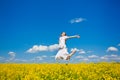 Young woman jumping on field Royalty Free Stock Photo