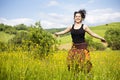 Young woman jumping in a field of flowers Royalty Free Stock Photo