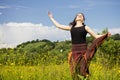 Young woman jumping in a field of flowers Royalty Free Stock Photo