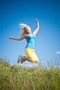 Young woman jumping on green meadow Royalty Free Stock Photo