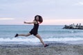 Young woman jumping happy at the beach, working out Royalty Free Stock Photo