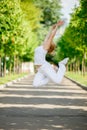 Young woman jumping high in city park Royalty Free Stock Photo